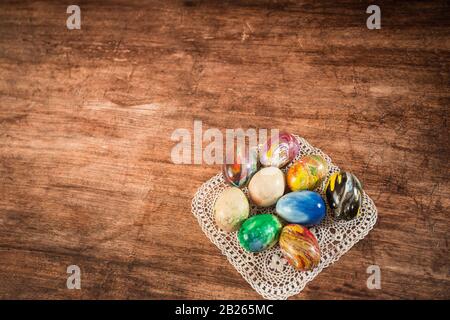 Some Easter eggs in a group on the wooden background. Stock Photo