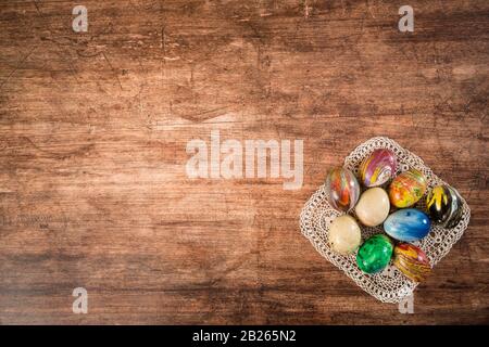 Some Easter eggs in a group on the wooden background. Stock Photo