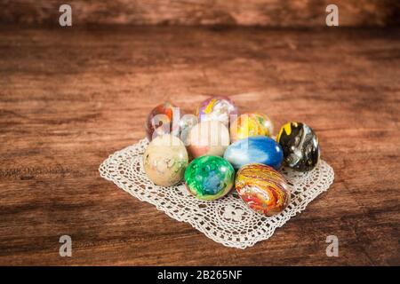 Some Easter eggs in a group on the wooden background. Stock Photo