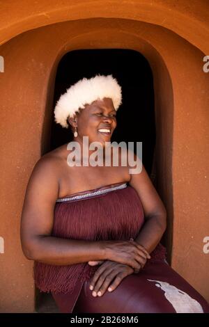 Basotho woman in a traditional hut, Thaba Bosiu Cultural Village, Lesotho Stock Photo