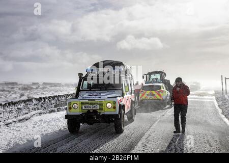 Teesdale, County Durham, UK. 1st March 2020. UK Weather.  The Teesdale and Weardale Search and Mountain Rescue Team, Police and snow plough driver Dan McLaughlin battled through deep snow and blizzard conditions at the height of Storm Jorge to rescue 8 off roaders, which included a child, who were trapped in 4 vehicles overnight on a remote moorland track near Coldberry End in Upper Teesdale.   Credit: David Forster/Alamy Live News Stock Photo