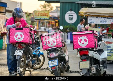 Fast food delivery service by motorcycle in Bangkok. Stock Photo