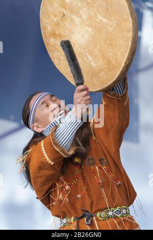 Aboriginal dancer in traditional clothes of native people dancing with tambourine. Concert Koryak Dance Ensemble Mengo. Kamchatka Peninsula Stock Photo