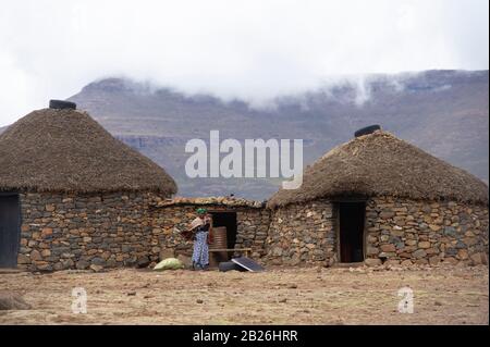 Woman outside her hut, Basotho village, Sani Top, Lesotho Stock Photo