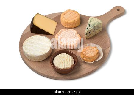 Wooden cheese board with a variety of cheeses for dessert close up isolated on white background Stock Photo