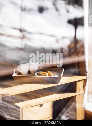 French croissants with black coffee on the table in the hotel room on breakfast Stock Photo
