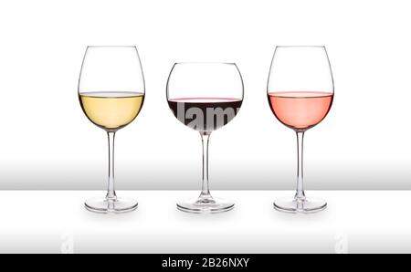 Three glasses of wine, white, red and rose, on a white bar like surface, with a white background Stock Photo