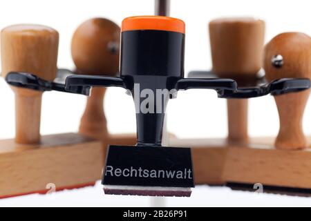 Close-up of  a stamp holder with many stamps - one of them with the german word for advocate, lawyer or attorney Stock Photo
