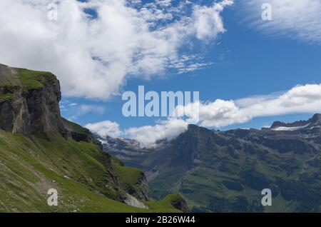 Beautiful mountain in summer with snow, green meadow and blue sky in Switzerland. City of Leukerbad, canton Valais, high Gemmipass on 2200 meters. Stock Photo