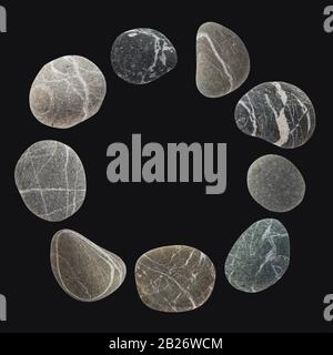 Round frame from a set of different color stones. Stock photo element Scandinavian trend design on dark background. Stock Photo