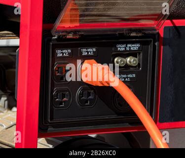 Portable emergency power electricity generator with power cord. Concept of electrical outage and natural disaster preparedness and safety Stock Photo