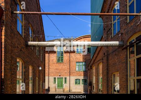 Alley at old industrial buildings Stock Photo