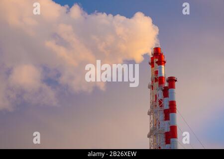 Smokestacks against a clear blue sky.  Environmental issues and the concept of global warming Stock Photo