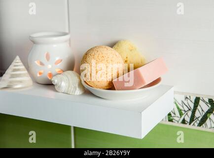 Bathroom products on simple minimal floating shelf indoors in bathroom. Stock Photo