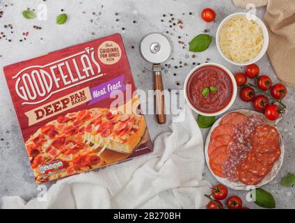 LONDON, UK - NOVEMBER 20, 2019: Box of Goodfella's Deep Pan BakedMeat Feast pizza with salami, cheese and tomatoes on light background. Stock Photo