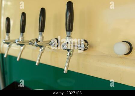 The beer taps in a side of a vintage van. nobody. Selective focus. Alcohol concept. Vintage style. Beer craft. Cold beer food truck in southern Brazil Stock Photo