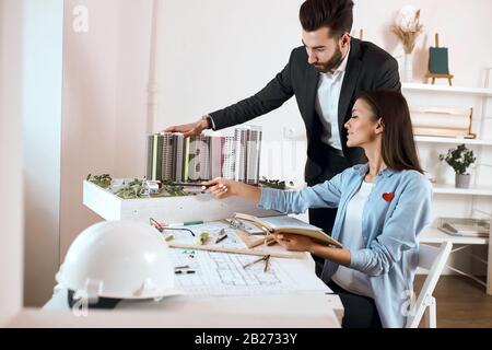 construction industry cconcept. man and woman developing interior and working on the planning of buildings.close up side view photo Stock Photo