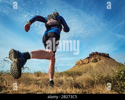 Athlete running in the desert wilderness. Butakov Bay Area in the northern part of the Small Aral Sea Stock Photo