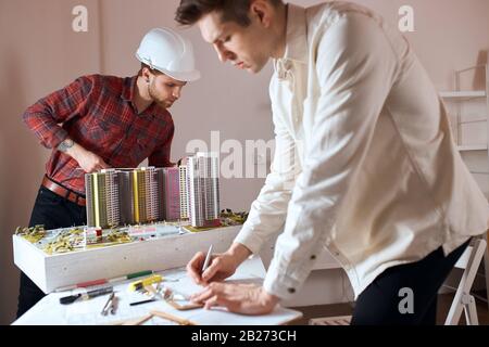 talented ambitious designer team working in office, two men working on architectural plan.close up photo. lifestyle, interest , hobby Stock Photo