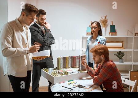 Confident ambitious serious team of engineers working together in the office with modern interior, brainstorming process. close up photo. job, profess Stock Photo