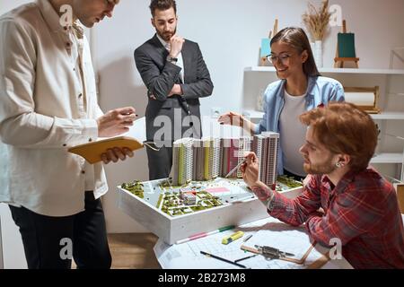 positive cheerful team working on business plan, developing interior of new neighbourhood. close up photo. friendship, faavourite job, pastime Stock Photo