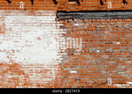 an old abandoned exterior whitewashed red brick garden building wall Stock Photo