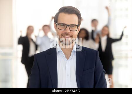 Close up portrait smiling millennial businessman in office. Stock Photo