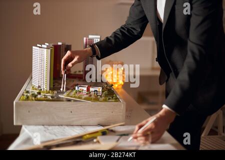 architect training in art, using pair of compasses, close up cropped side view photo. Stock Photo