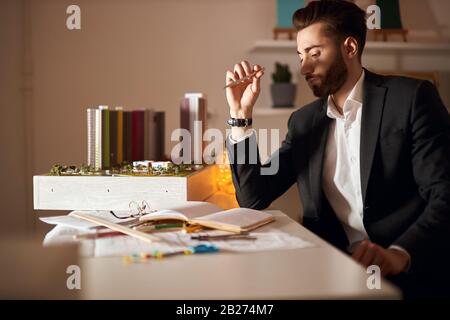 serious man is concentrated on designing building and other structures.close up side view photo.architectural, construction and engineering industry Stock Photo
