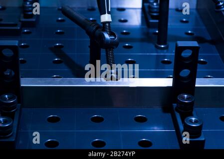 New chrome-plated fixing latch. Accessories for a mechanic and metal procesing. Dark background. Stock Photo