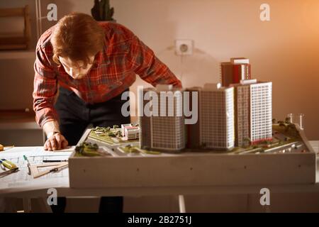 young skilled designer analyzing studing on the blueprint. close up photo. making a project, developing , designing a new layout. creativity. close up Stock Photo