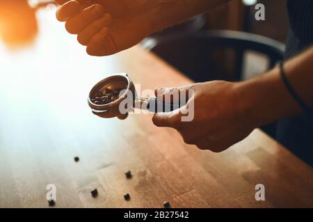 roasted coffee beans in a holder before cooking on the background, close up side view photo Stock Photo