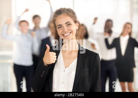 Close up portrait smiling millennial businesswoman in office. Stock Photo