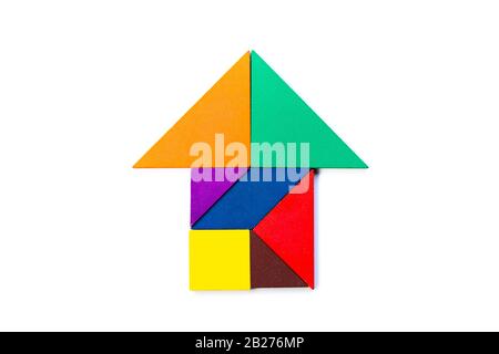 Color wood tangram puzzle in arrow or home shape on white background Stock Photo