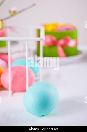 Colorful eggs for Easter day and small cake on the background Stock Photo