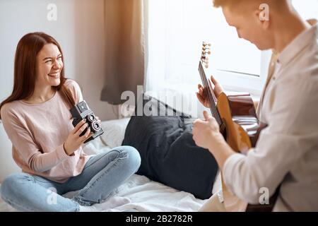 young talented musicial posing to the retro camera, close up side view cropped photo, free time, spare time, lifestyle Stock Photo