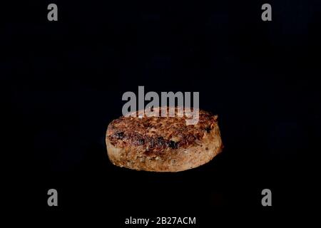 cutlet on burger on a black background Stock Photo