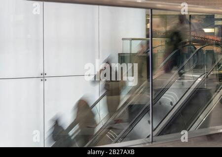 Motion blur people on escalator Stock Photo