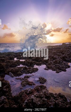Waves crashing into rocks big splash at Grand Cayman blowhole Stock Photo