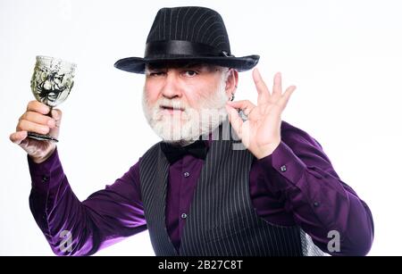 Trick or Treat. barman make cocktail for halloween party. halloween holiday costume. evil wizard cooking magic potion with spider. happy halloween. mature man magician in witch hat. Stock Photo
