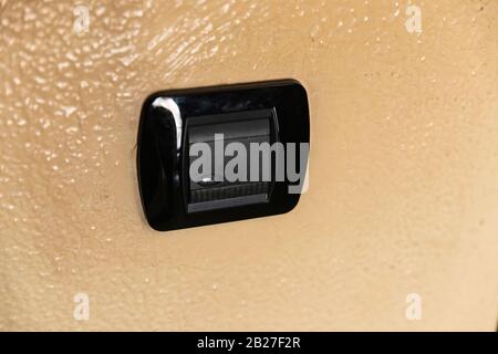 a black plastic light switch Stock Photo