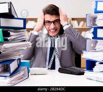 The busy businessman under stress due to excessive work Stock Photo