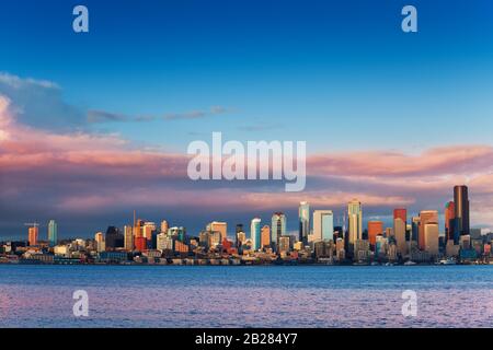 Seattle waterfront downtown buildings wide skyline view at evening sunset on spring day, Washington, USA Stock Photo