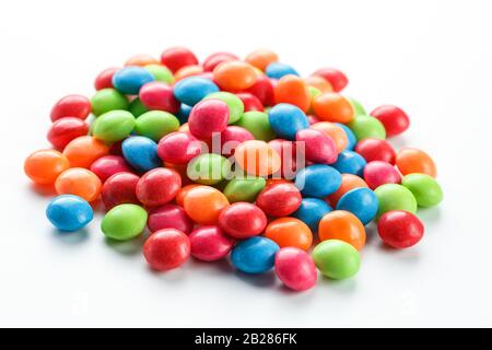 Rainbow-colored candies, multicolored close-up, texture and repetition of dragee Stock Photo