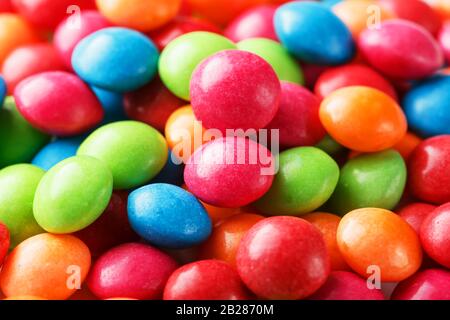 Rainbow colors of multicolored candies close-up, texture and repetition of dragee Stock Photo