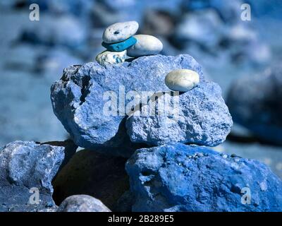 Stack of stones for balance and harmony in bright colors Stock Photo