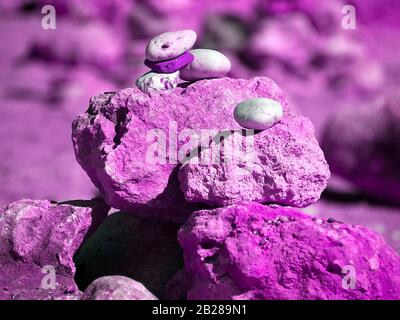 Stack of stones for balance and harmony in bright colors Stock Photo