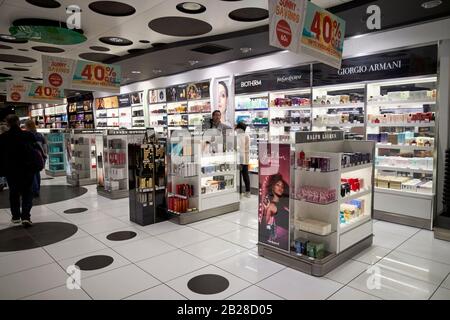 passengers walking through perfume and duty free shopping in terminal t1 arricife cesar manrique-Lanzarote airport canary islands spain Stock Photo