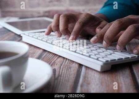 Close up of man hand typing on keyboard  Stock Photo