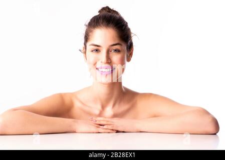 Close-up shot of gorgeous young woman with perfect skin wearing purple lipstick while posing at isolated white background with copy space. Stock Photo